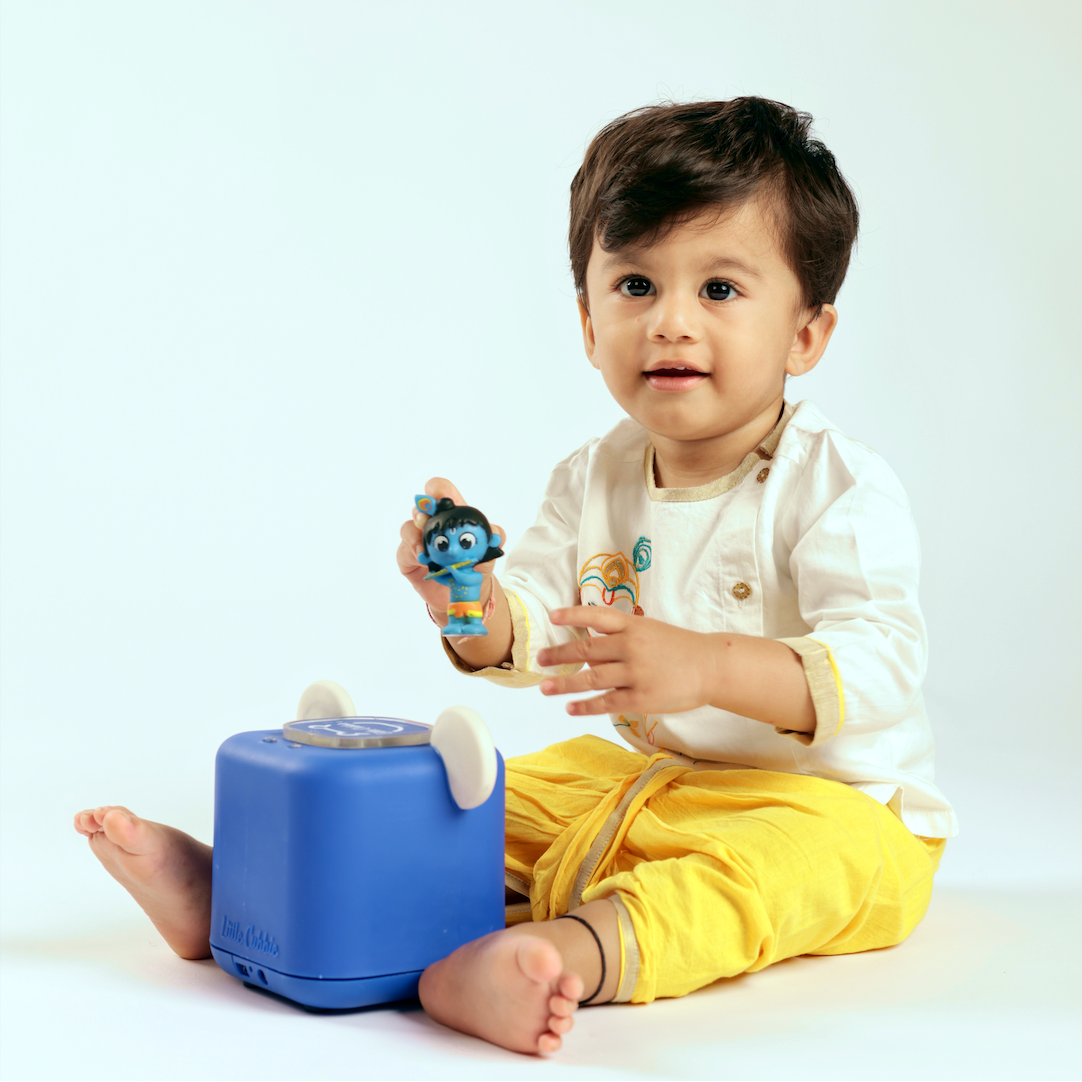 Child playing with little cubbie on a white background